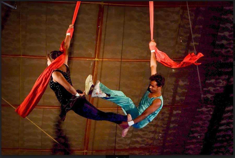 FLIGHT FOR EXISTENCE: Artistes perform flying trapeze at a circus, to near-empty audience stands during the third wave of COVID-19 in Kolkata on Monday, January 10. Once an annual winter attraction for the old and young, circuses in recent times have been dealt a double whammy of implementation of animal ban and dipping footfall