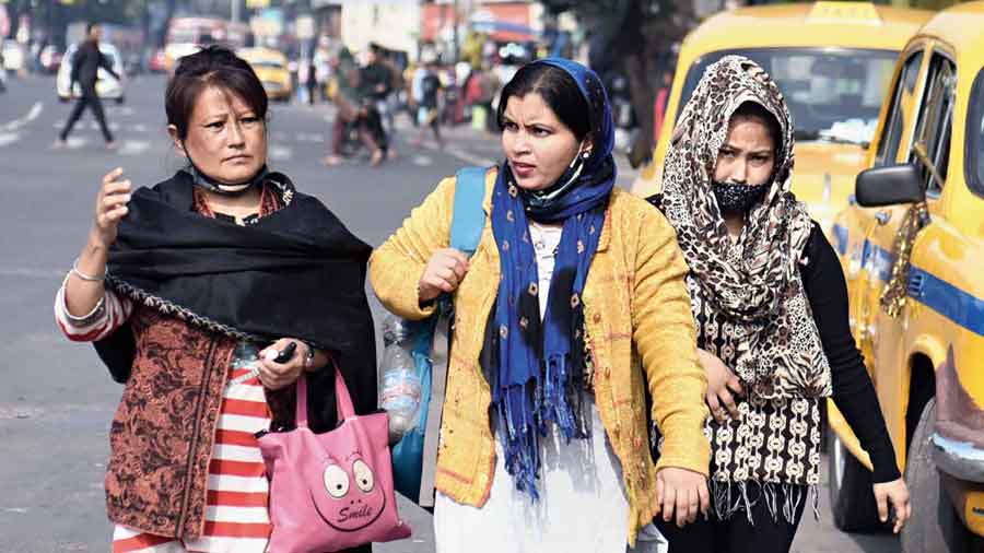 Three women were  walking down the road  in Esplanade, two of  them without  masks. When the photographer asked  them, one of them said:  “Yes, we will  wear masks.”