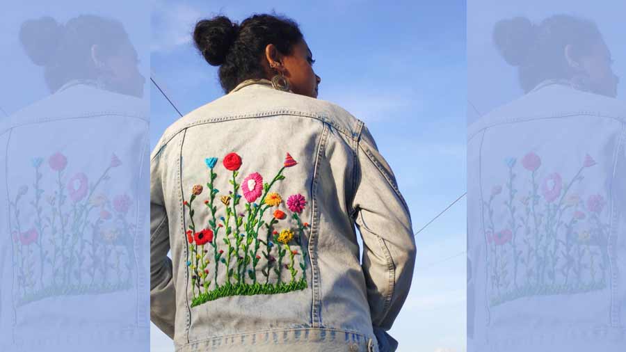 An embroidered back panel on a denim jacket