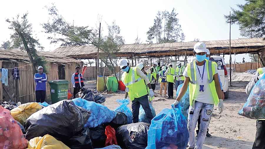 Teams collect plastic waste from the Gangasagar Mela area