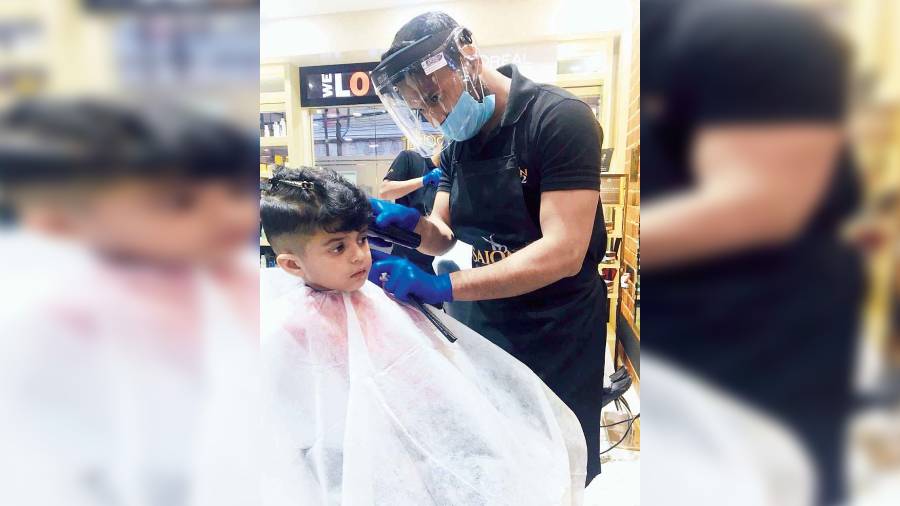 A child gets his hair cut at Salon 82.