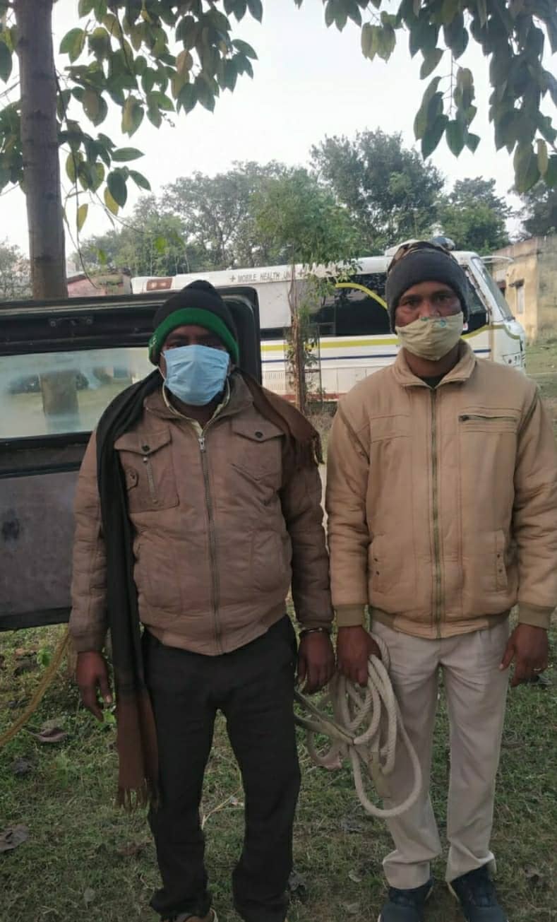 The arrested Kamar Singh Parihar (left in blue mask) in police custody near SSP office in Bistupur