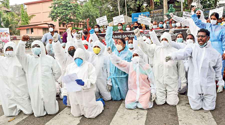 Health workers under the aegis of the Covid Brigade Association stage a protest  in Thiruvananthapuram on Saturday.