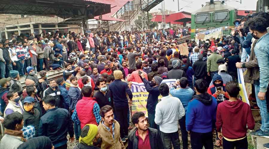 Students and candidates protest at the Rajendra Nagar station in Patna on Monday evening.