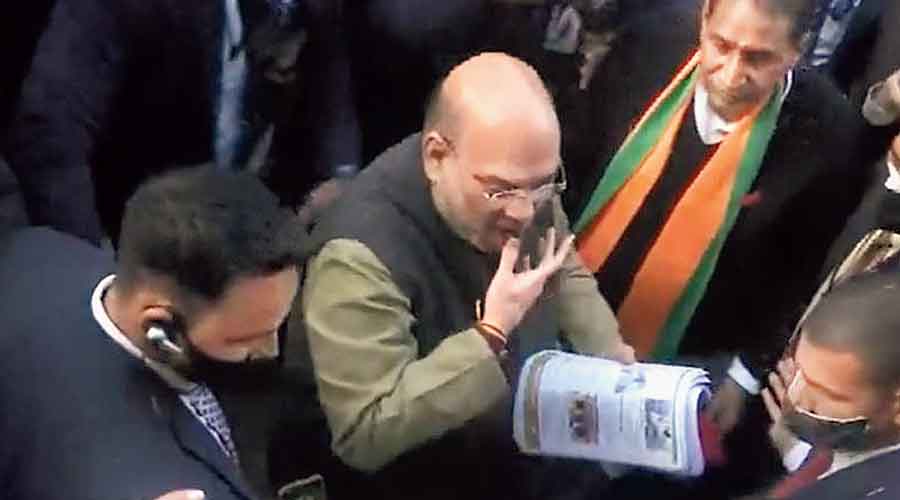 In ANI footage, Shah appears to moisten his  thumb before distributing campaign fliers in  Dadri, Uttar Pradesh, on Thursday.
