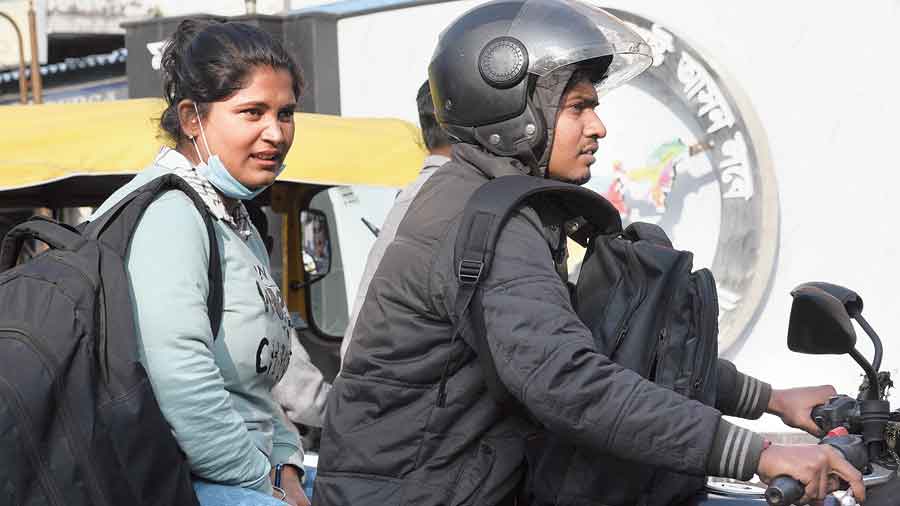 At a traffic signal in Phoolbagan, a biker and a woman riding pillion were both without masks. “It is very hot so I am not wearing a mask,” the woman said.