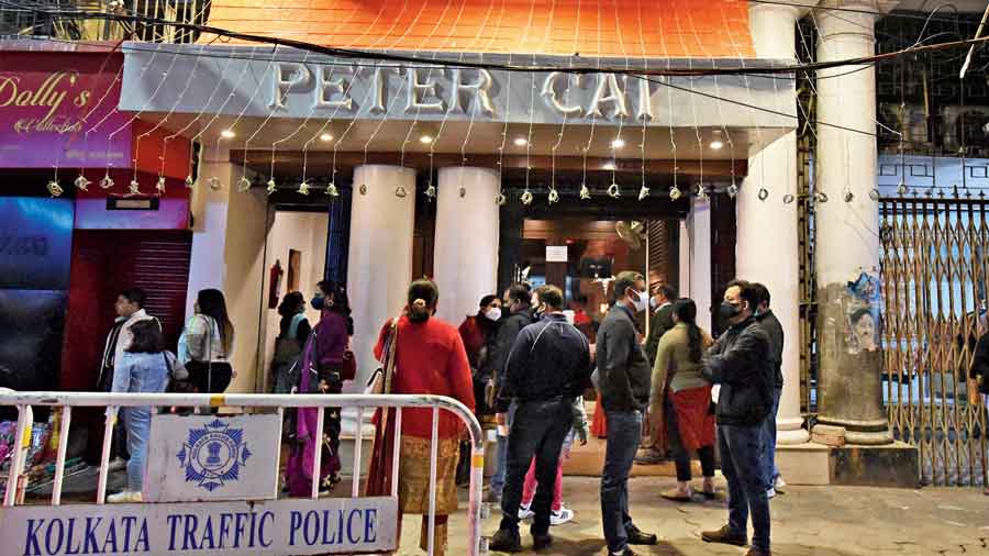 Diners wait outside Peter Cat restaurant on Park Street around 8pm on Friday. 