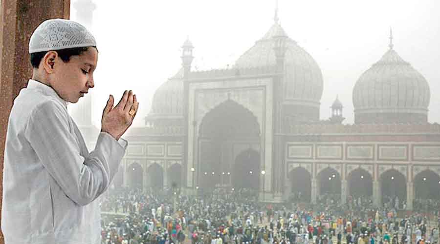  A boy offering Namaz on the occasion of Id-ul-Zuha at Jama Masjid in New Delhi.