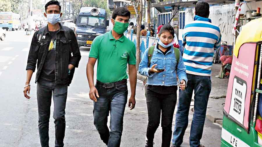 A woman walking down a road in Jodhpur Park had  her mask on her chin. “I am wearing a  mask… I am walking,” she said.