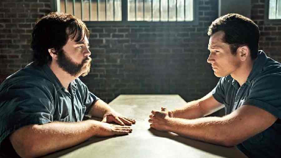 Taron Egerton and Paul Walter Hauser (left) in Black Bird, premiering globally July 8 on Apple TV+. 