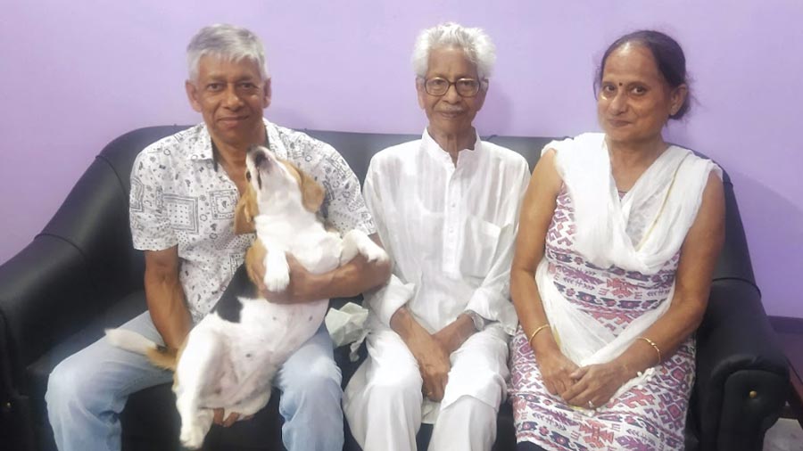 Das Sarma flanked by his son, his daughter-in-law Vibha and the family beagle, Snoopy