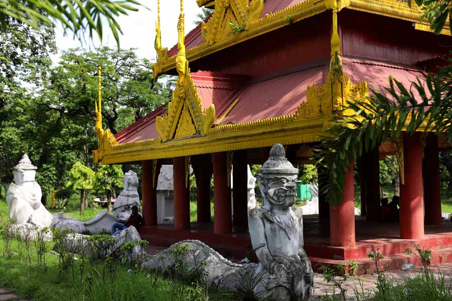 Intricate wood carvings and statues of mythological creatures can be seen all around the pagoda whose reflection can be seen in the adjacent lake. 