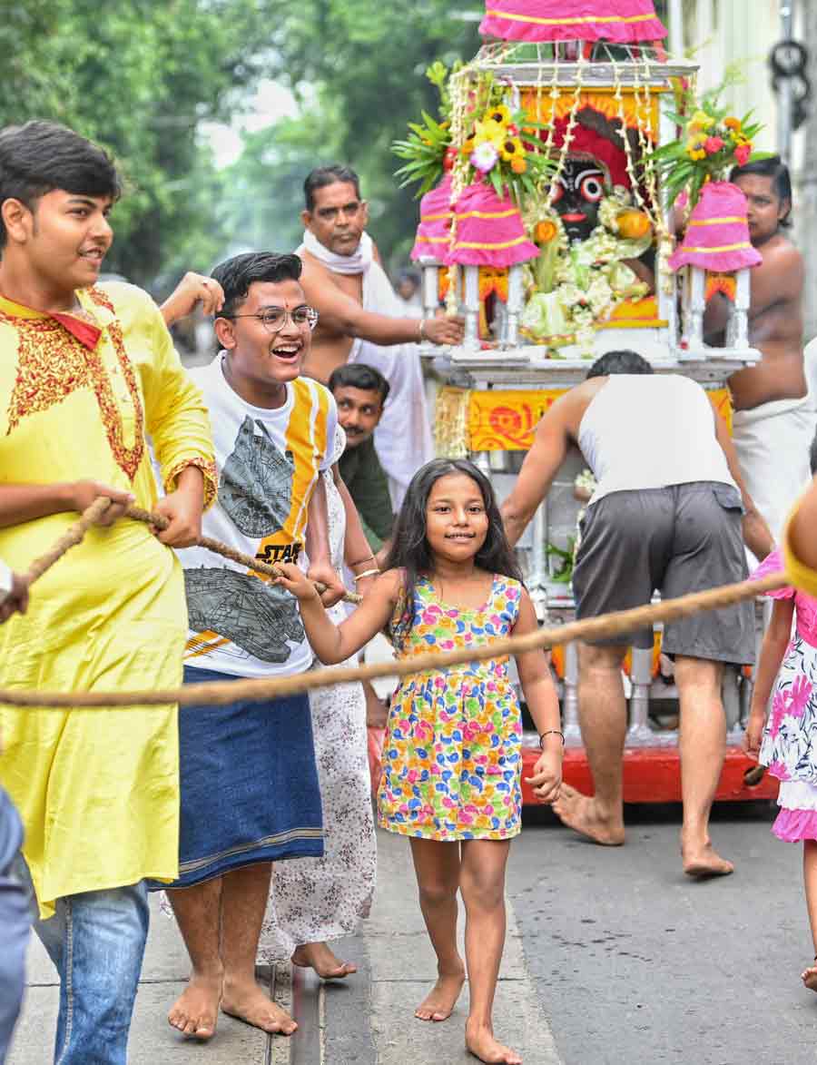 Children walk barefoot at a Rath Yatra procession near Bagbazar on Friday.