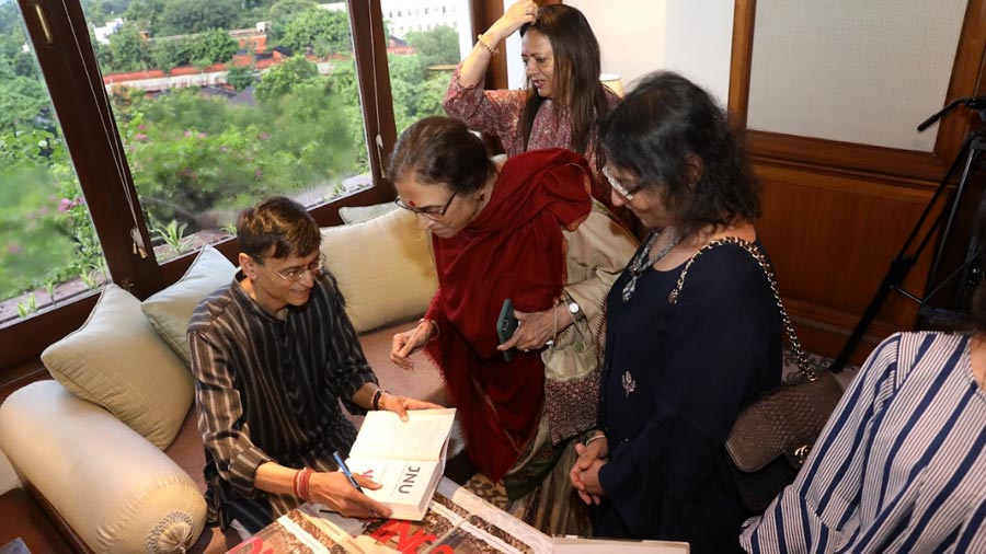 Paranjape signing copies of his book following the discussion