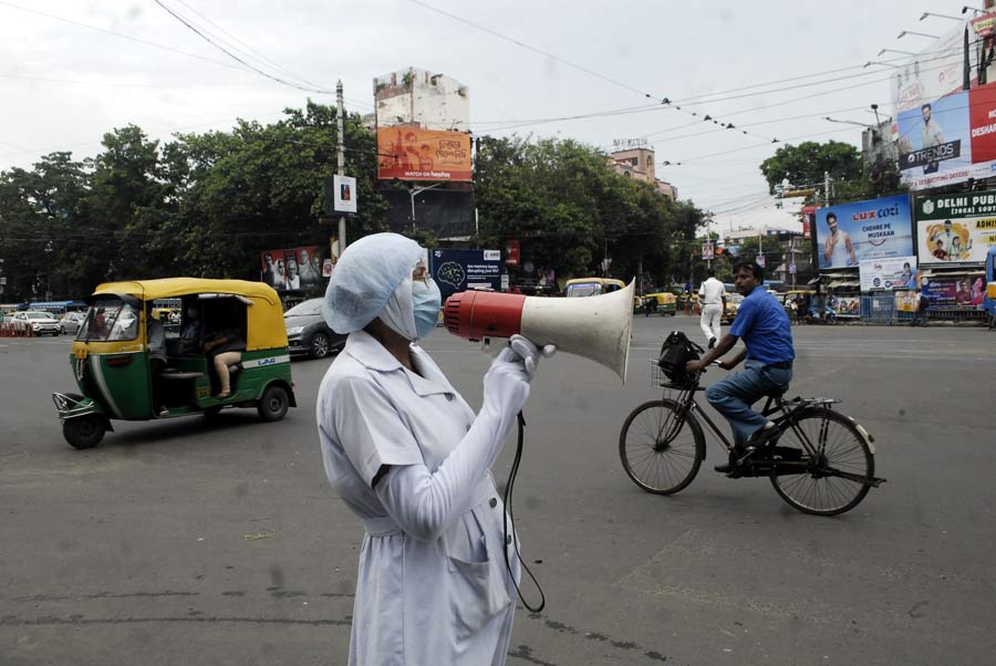 Gita Dey, a former nurse, uses a loudhailer to spread awareness about traffic rules on Thursday, June 30.
