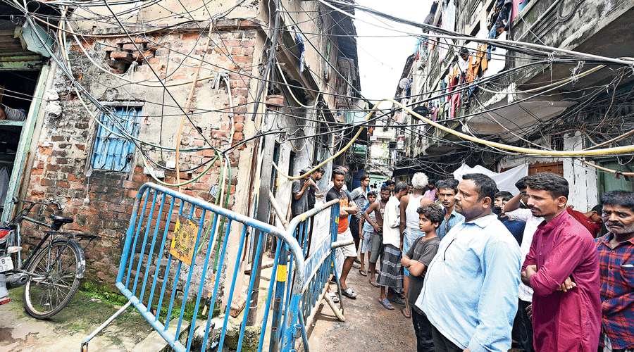The electric pole (surrounded by guard rails) in Narkeldanga on Sunday, which residents said Farzan Ansari  had touched and got electrocuted the day before.