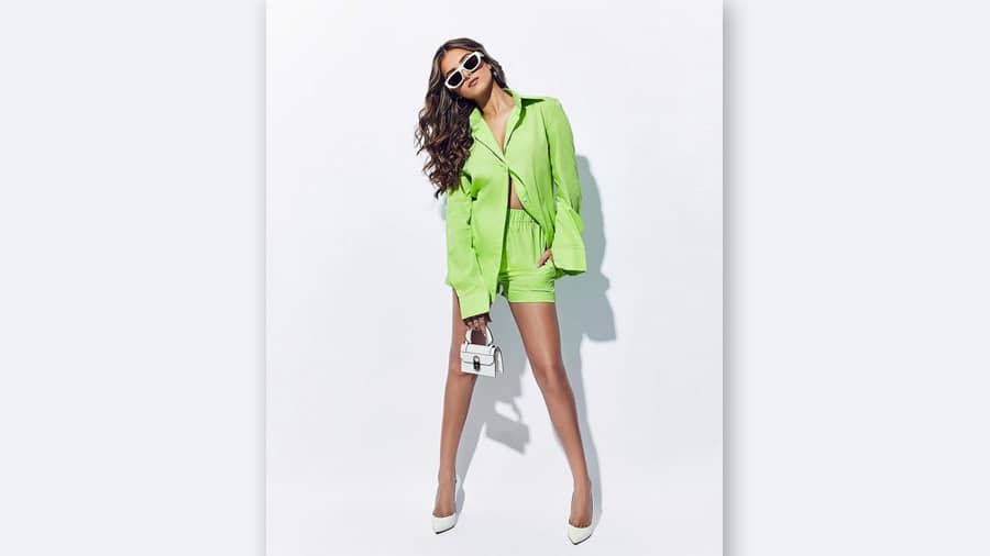 In a parrot green oversized coord set, broad-rimmed sunnies and white heels, Tara takes summer fashion a notch higher. She accentuated the look with loose curls and a white Christian Louboutin bag.