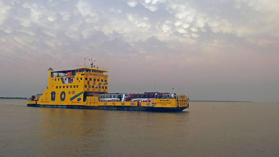 A vessel with passengers and buses arriving at Daulatdia Ferry Ghat