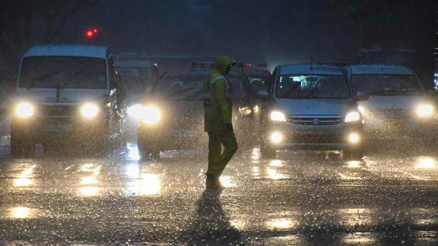 Vehicles ply on a road amid monsoon rains, in Mumbai
