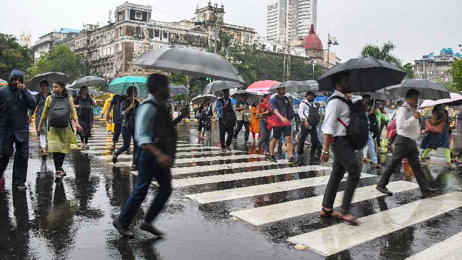 People holding umbrellas take a stroll amid heavy rains