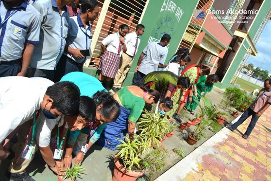 Students and teachers taking active part in sapling plantation activity at Gems Akademia International School, Kolkata. 