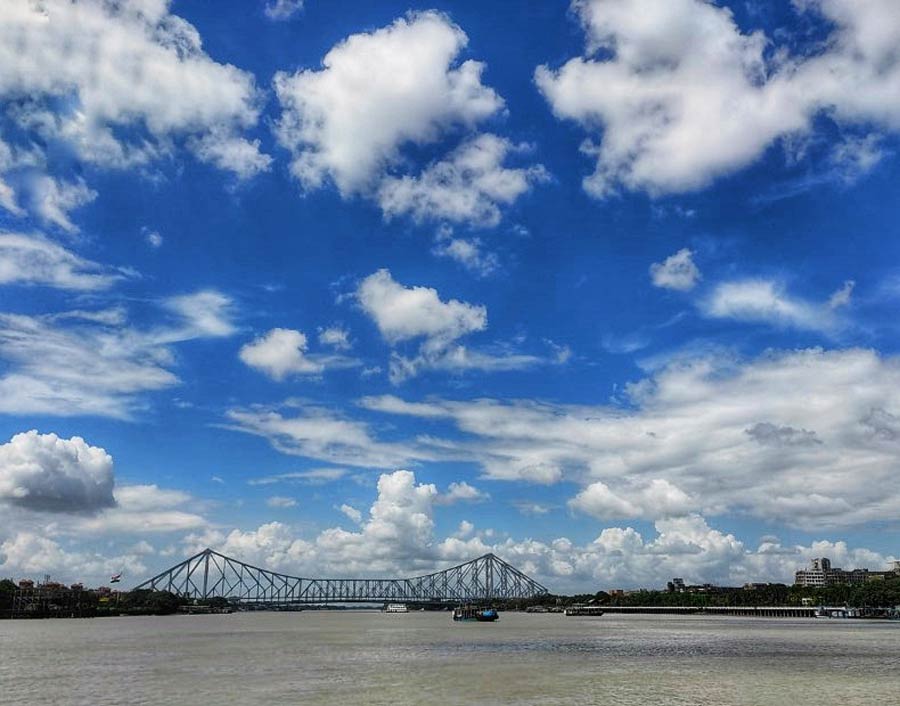 Blue skies, white cotton clouds sailing by and the Howrah bridge on the horizon — an untimely impression of autumn in the middle of monsoon, on Thursday.
