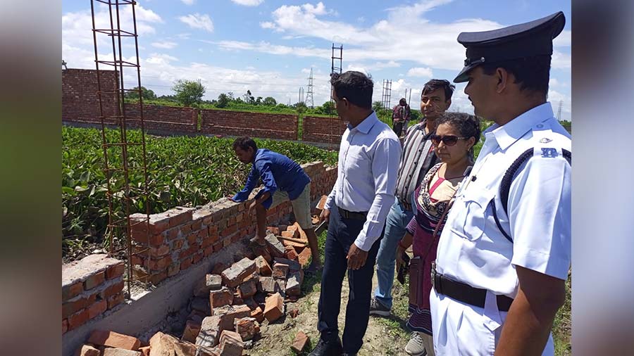 EKWMA chief technical officer K. Balamurugan supervises the demolition of the illegal construction.