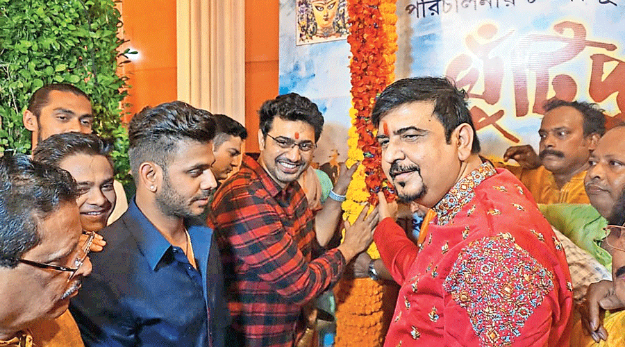 Sujit Bose with guests Dev and Manoj Tiwari (in blue shirt) and Tapash Chatterjee at the khuti puja on Friday.