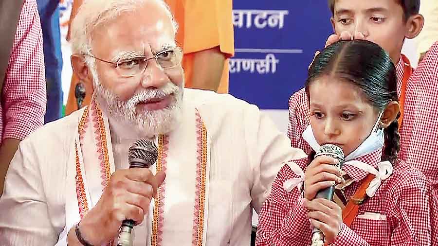 Prime Minister Narendra Modi with schoolchildren at the inauguration of an Akshay Patra midday meal kitchen building in Varanasi  on Thursday