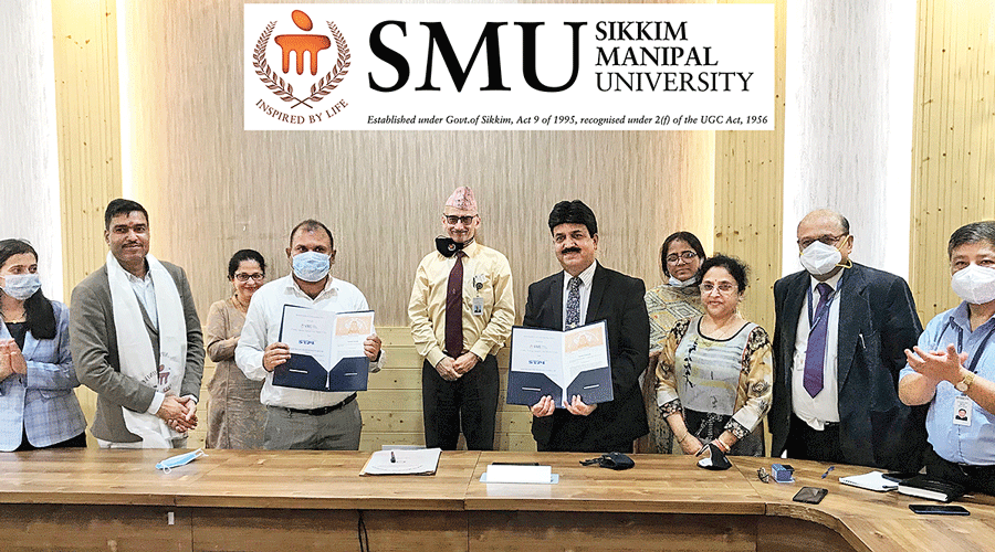 Representatives of Sikkim Manipal University and STPI at the MoU  signing ceremony in Gangtok on Thursday.