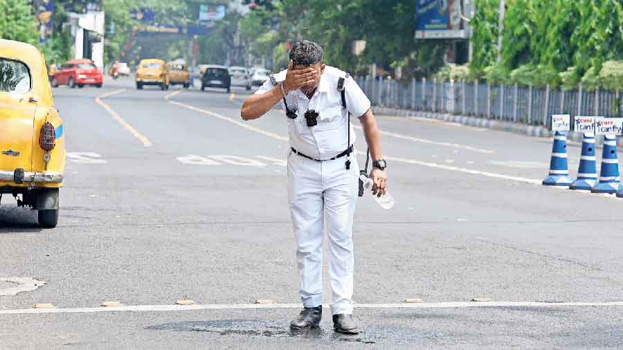 A cop tries to cool himself amid scorching heat in Calcutta on April 24