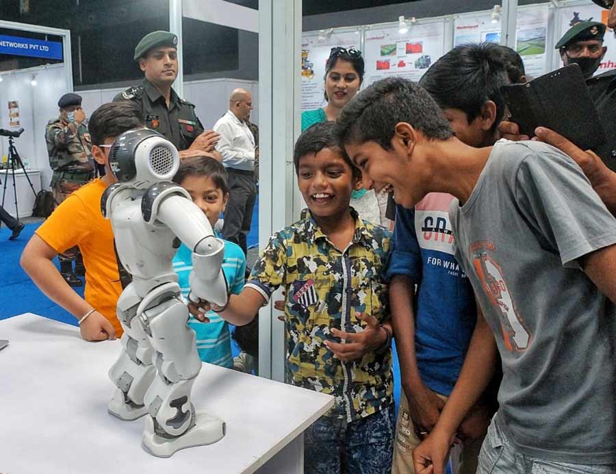 Children enjoy the sight of a robot at the exhibition. The two-day event had 187 exhibitors at 269 stalls.