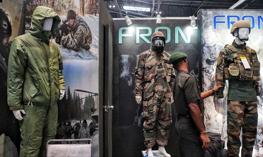 A soldier checks out various protective outfits on display. These high-durability outfits are made to help soldiers stay safe during high-risk military operations.