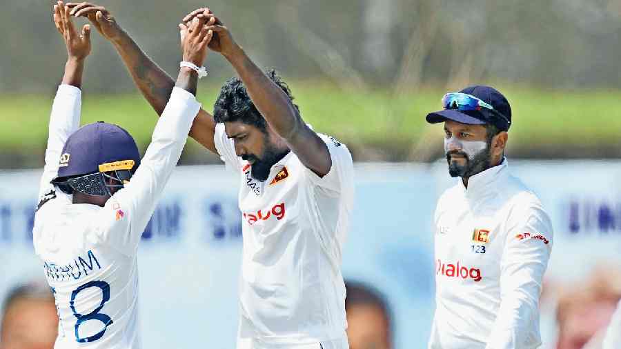 Sri Lanka’s Prabath Jayasuriya (right) celebrates with a teammate after taking the wicket of Australia’s Alex Carey in Galle on Saturday. 