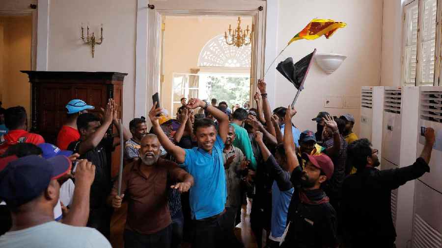 Hundreds of anti-government protesters on Saturday stormed into Rajapaksa's residence in central Colombo's high-security Fort area