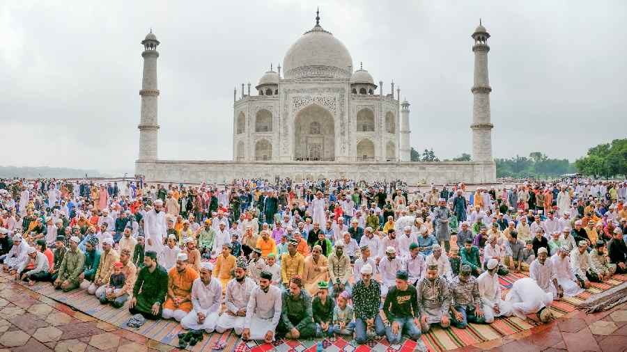 Muslim devotees offer prayers on the at the Taj Mahal complex in Agra
