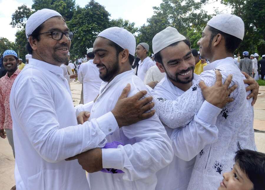 People greet each other after offering prayers on the occasion of Eid on Sunday.