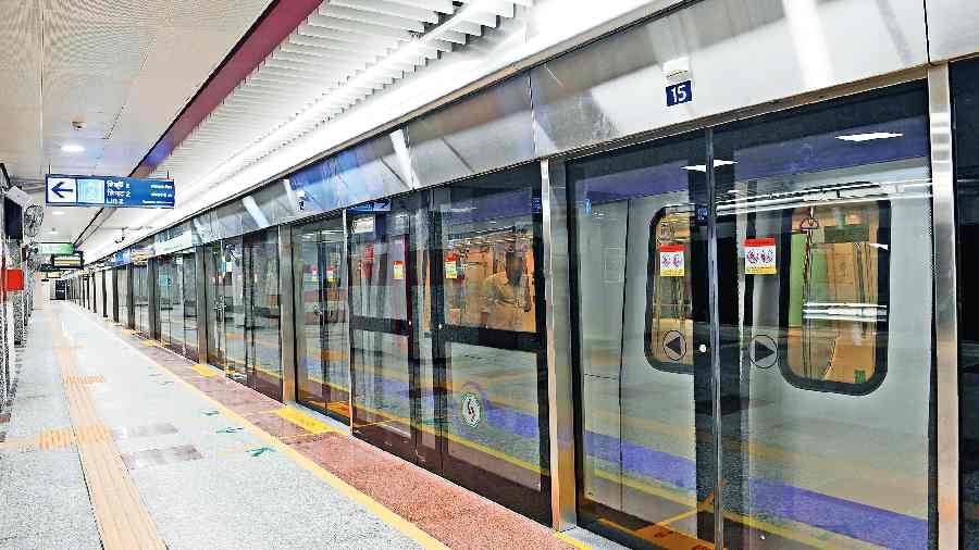 The train that made the ceremonial run seen through platform screen doors at  the Sealdah Metro station