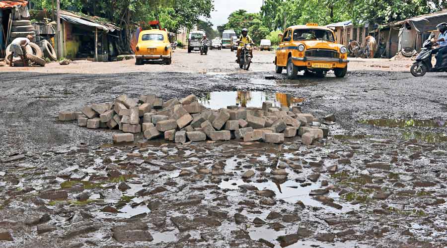 A file photograph of a cratered road in Kolkata