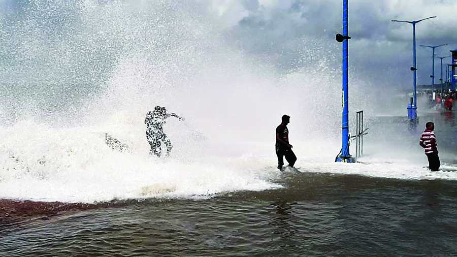 Tourists on Digha beach during high tides on Wednesday. 