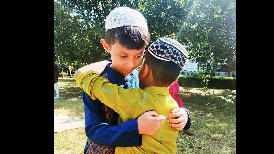 Children embrace after the prayers.