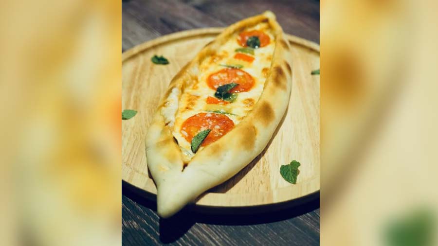 The cafe offers Modern European cuisine and the menu features some shareable picks like Cheese Tomato Pide (a type of Turkish flatbread)
