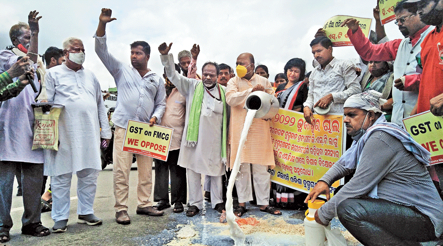 Farmers pour milk on the streets near the Odisha Assembly in Bhubaneswar in protest against the imposition of GST on dairy products.