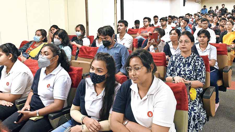 Students and invitees listen to the debate at Techno India University.