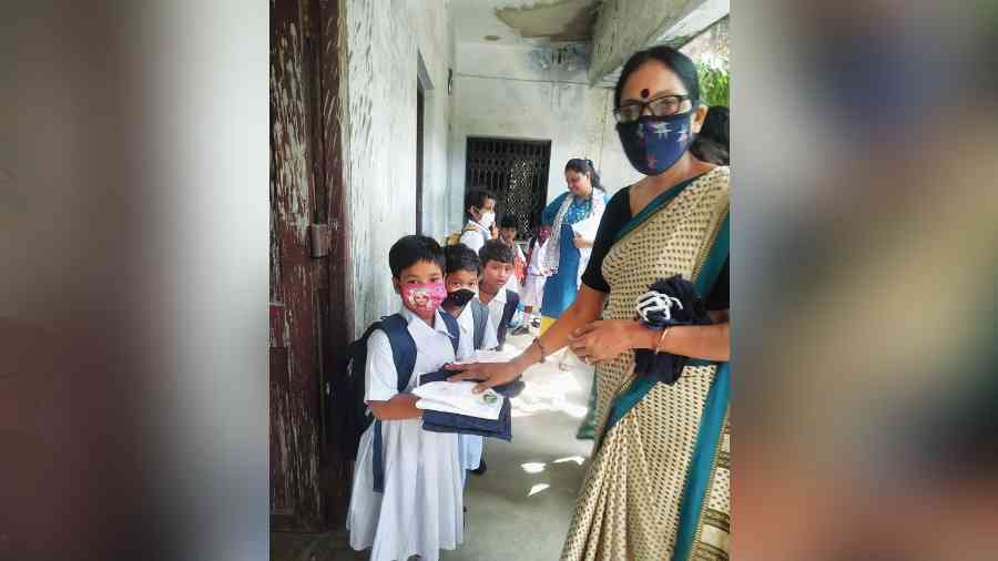 Uniforms being distributed in a primary school in south Kolkata on Tuesday