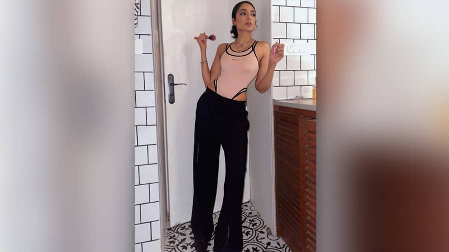 Staple, sensuous and multi-purpose — we love how the model-turned-actress amps up athleisure fashion. In a nude, double bodysuit from Polite Society, paired with classic black pants, statement neckpiece and kohl-lined eyes, Sobhita is ready to take on the world.