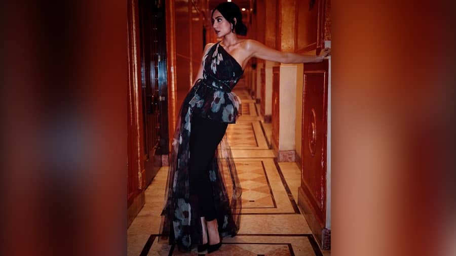 Take a cue for partywear from the actress, who will next be seen in the film Sitara, and the American action thriller Monkey Man with actor Dev Patel. Seen here, sporting a Gauri and Nayanika one-shoulder ruffle floral top, teamed with black pants, bold lips, monotone nails and black stilettos — we are impressed, Sobhita!