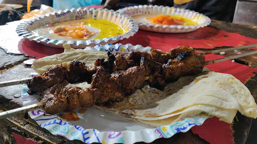 Seekh tujj or skewered meat cooked over charcoal, wrapped in lavasa or unleavened flat bread