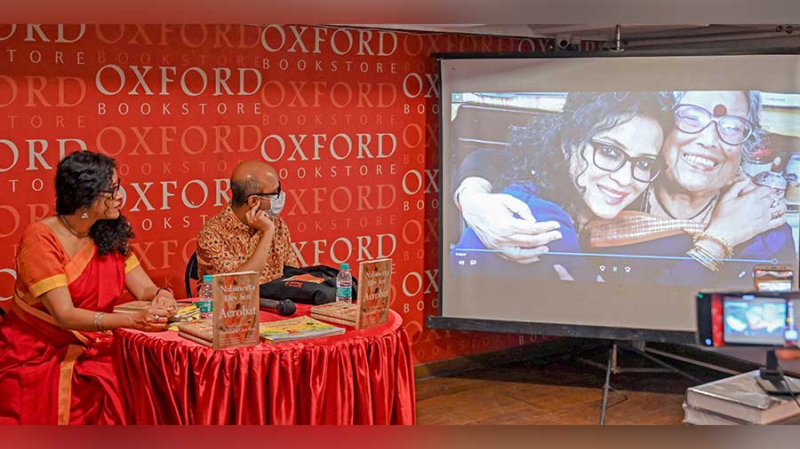 Nandana Dev Sen and Srijato Bandyopadhyay watch a montage of pictures of Nabaneeta Dev Sen before the start of the session at Oxford Bookstore