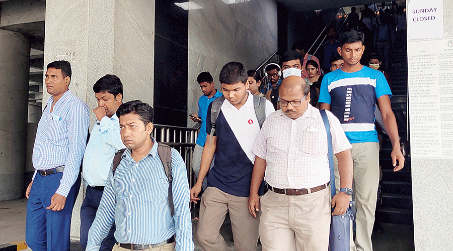 Office-goers exit the Sector V Metro station on Wednesday.